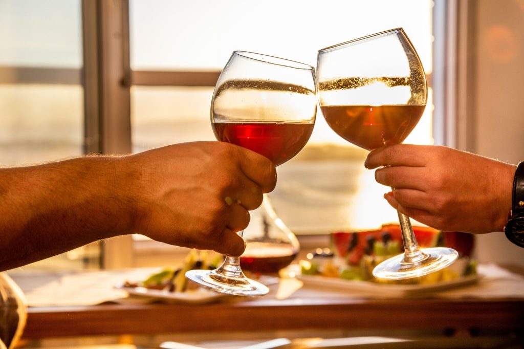 A file image of two people having a glass of wine.