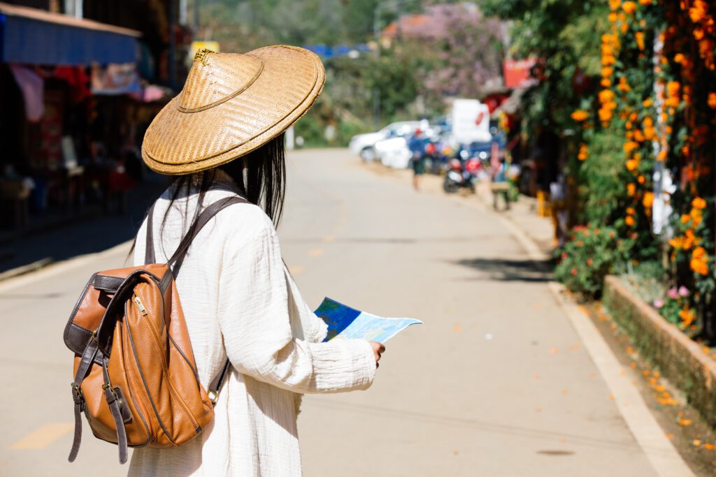 female tourists hand have happy travel map