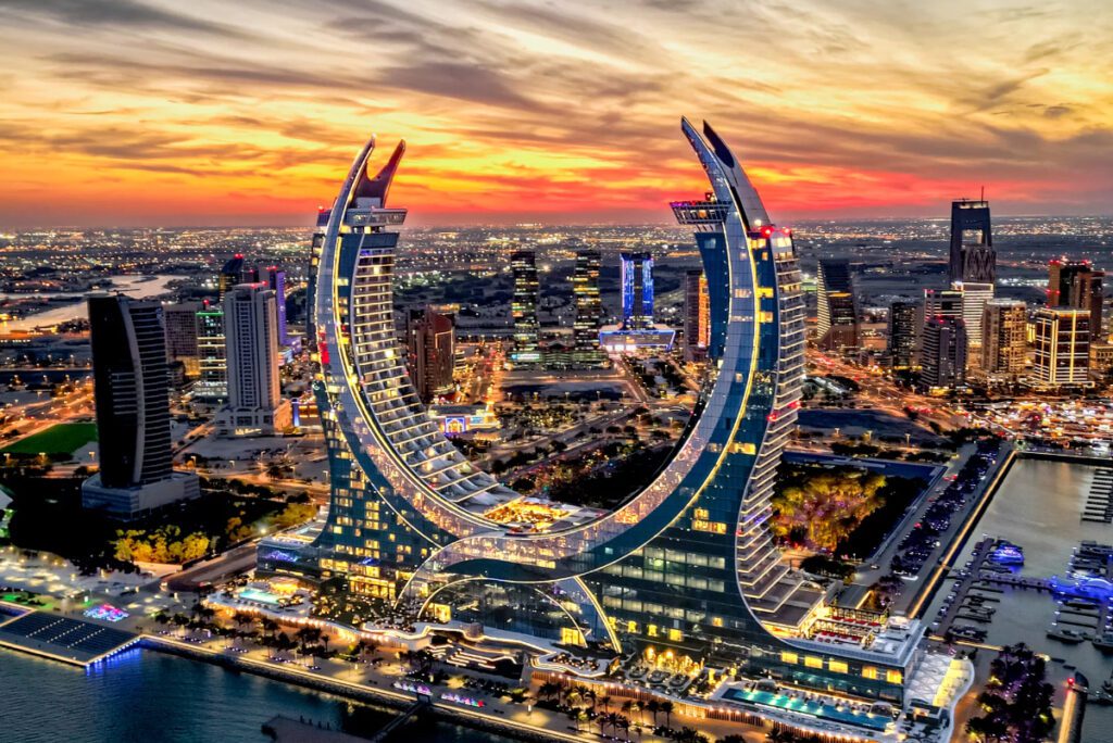 an ususual building that looks like two arabian swords crossed together on the skyline of doha, a city in Qatar in the united arab emirates