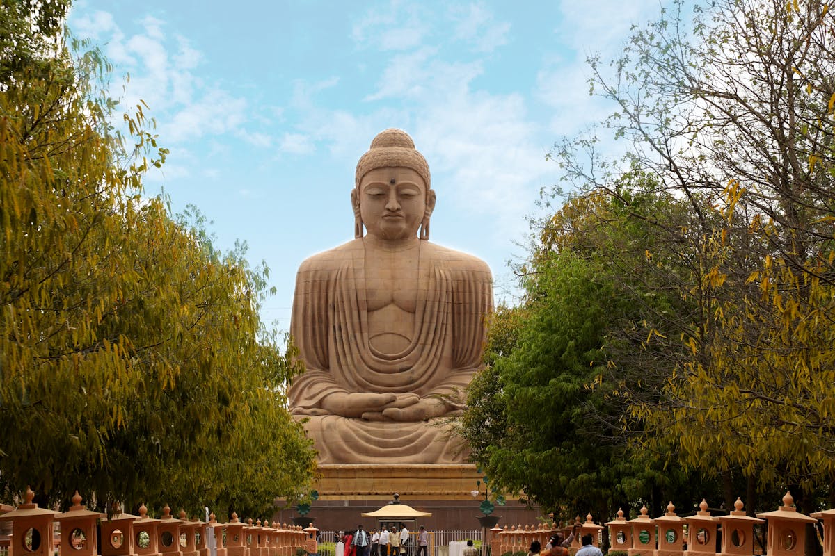 Tourists walking near the great Buddha statue in Bodh Gaya, India.