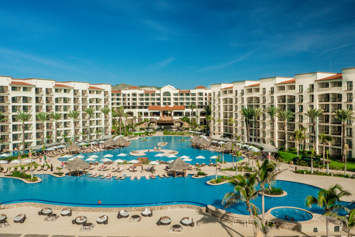 A view of a resort hotel with a big pool on a sunny day Hyatt Ziva Los Cabos