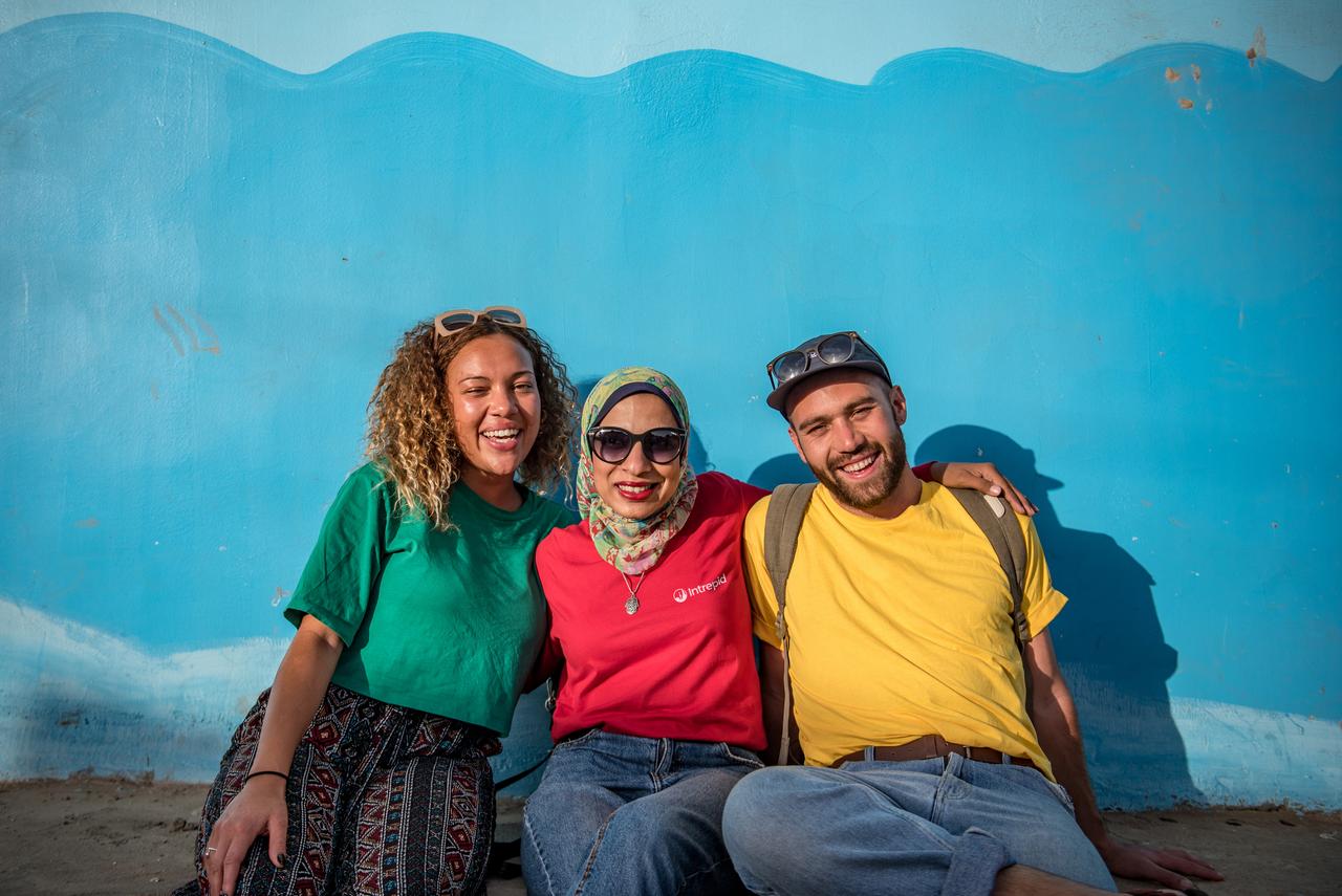 3 people sitting together on a tour in Egypt.