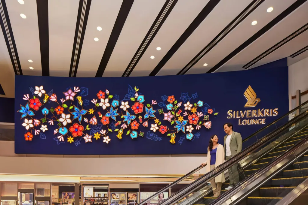 Two passengers exiting the Singapore Airlines lounge at Changi Airport.