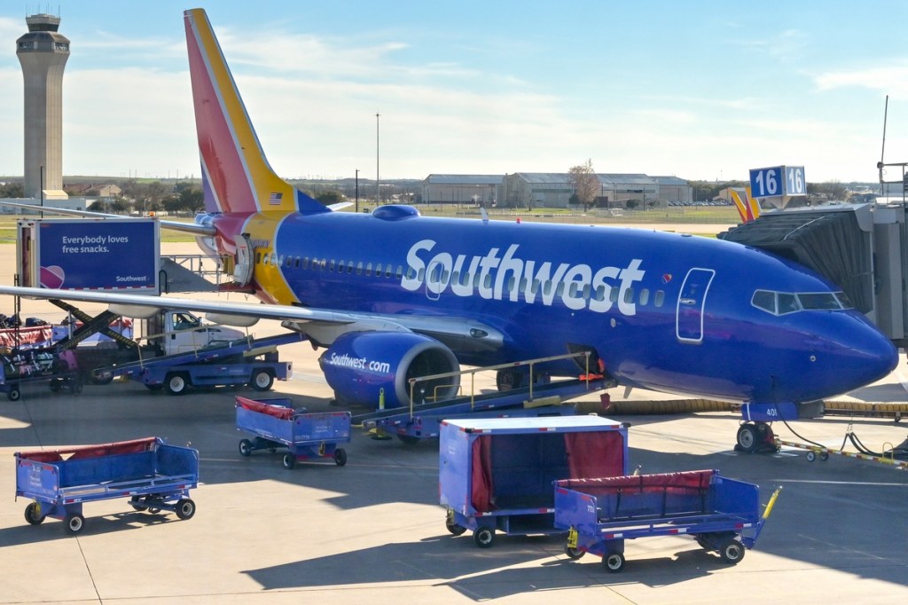 a plane on the tarmac surrounded by loading equipment.