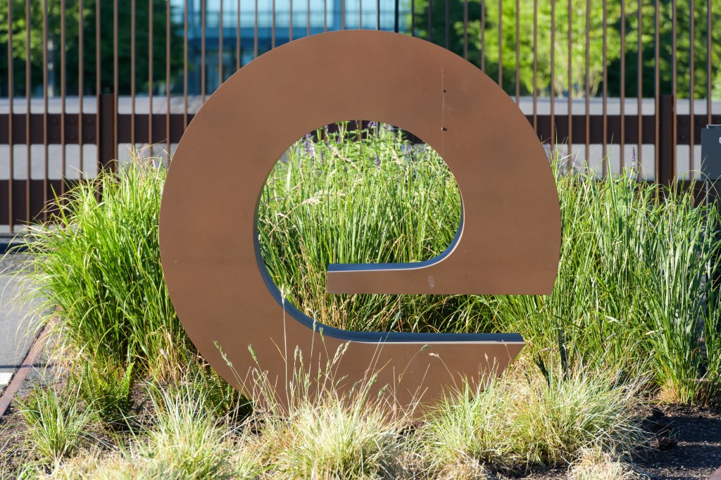 a logo in the shape of an E at the entrance to an office park