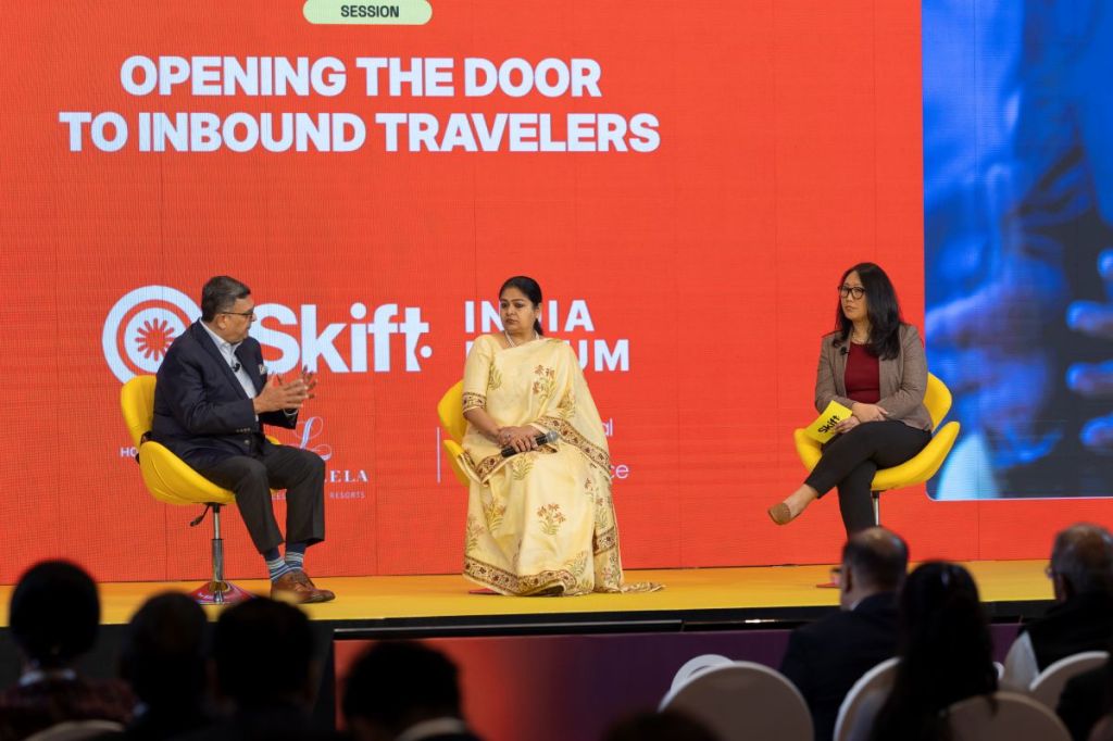 Dipak Deva, Managing Director and CEO of Travel Corporation India (Left) and Mugdha Sinha, Director General of Tourism, Government of India, with Skift Asia Editor Peden Bhutia at Skift India Forum 2025.