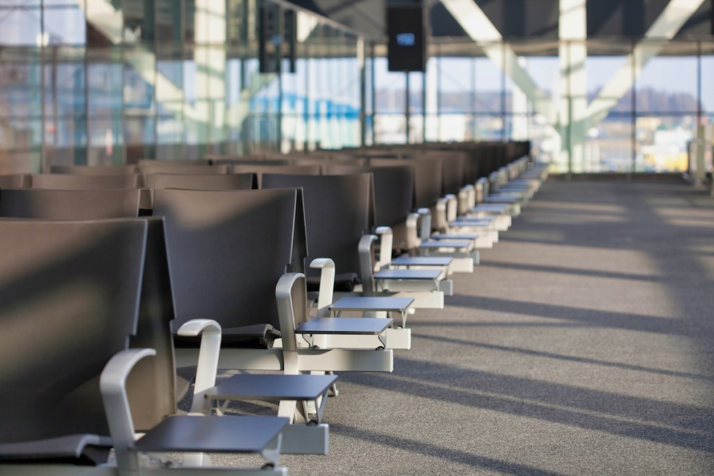 rows of empty seats at airport boarding gate