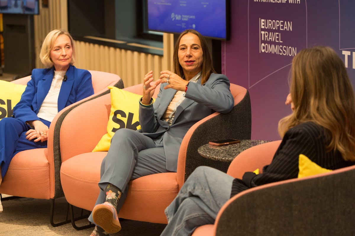three women speak on stage
