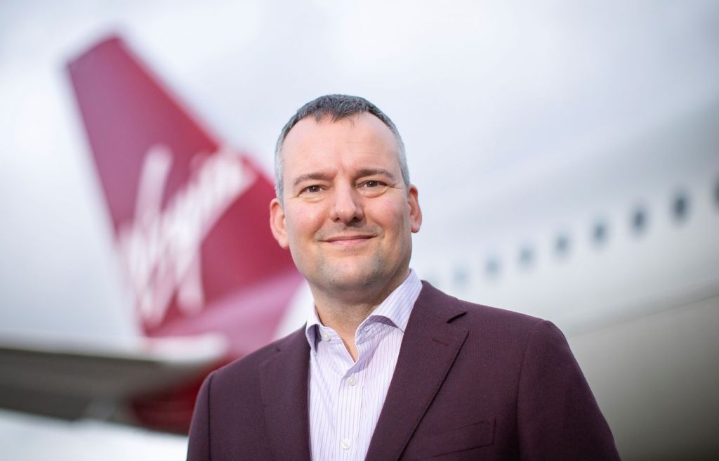 Corneel Koster beside a Virgin Atlantic plane.