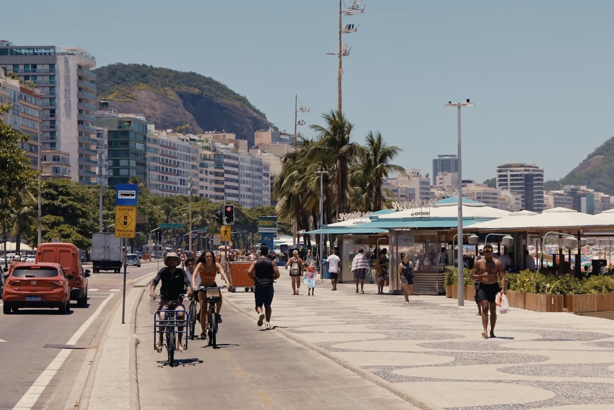 People walking near a beach in Rio de Janeiro.