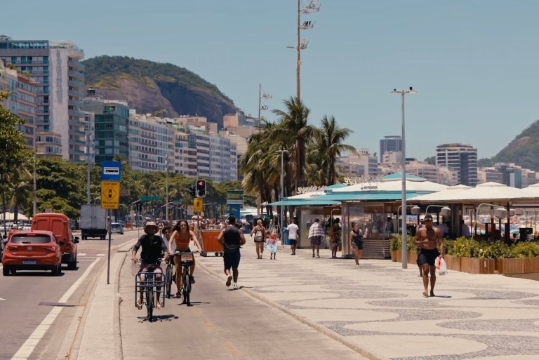 People walking near a beach in Rio de Janeiro.